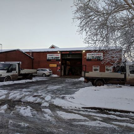 county tyres building in the snow